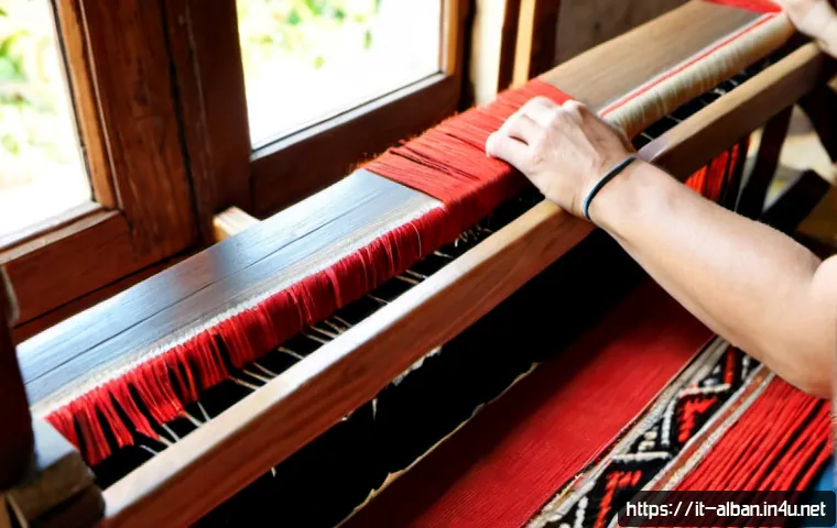 Home 11 알바니아 전통 공예품 - Photorealistic artisan workshop in Albania, close-up of skilled hands weaving a traditional red, bla...